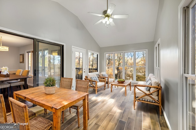 sunroom with a ceiling fan and lofted ceiling