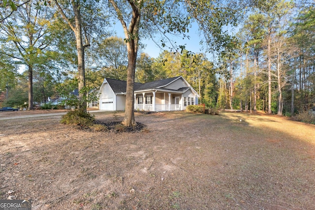 view of side of home with a garage and covered porch