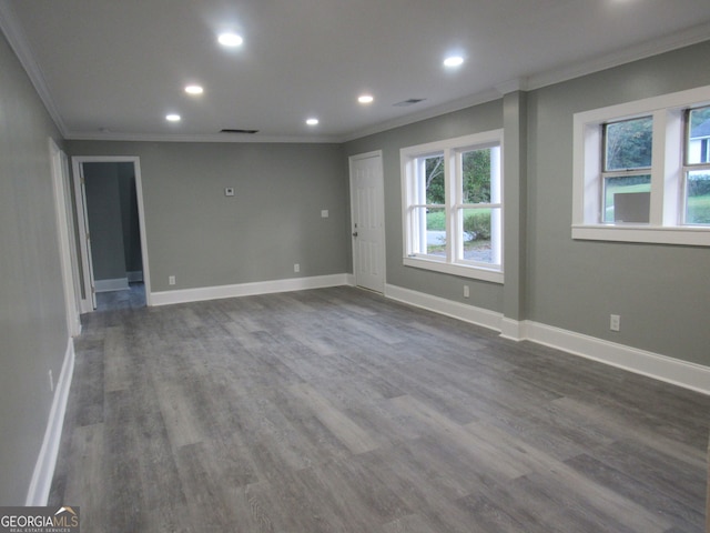 spare room with dark wood-type flooring and crown molding