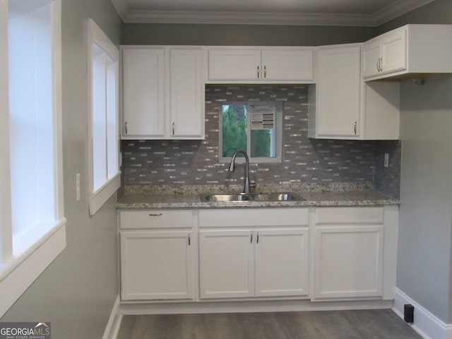 kitchen with decorative backsplash, white cabinets, a healthy amount of sunlight, and sink