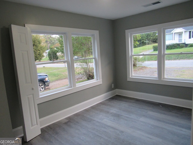 empty room with dark hardwood / wood-style flooring