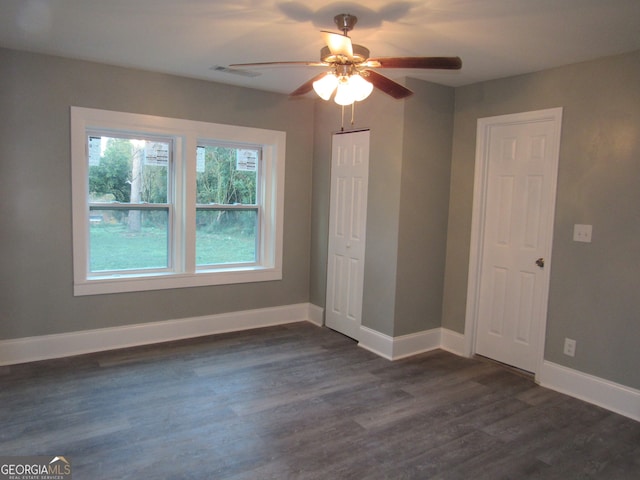 unfurnished bedroom with ceiling fan and dark hardwood / wood-style floors