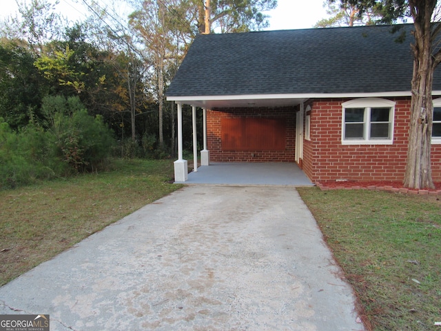 exterior space featuring a carport and a lawn