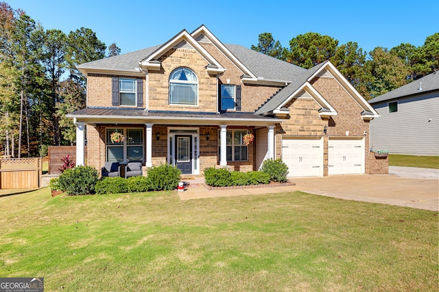 craftsman house featuring covered porch, a garage, and a front lawn