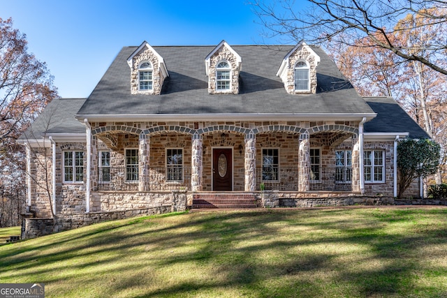 cape cod-style house with a porch and a front lawn