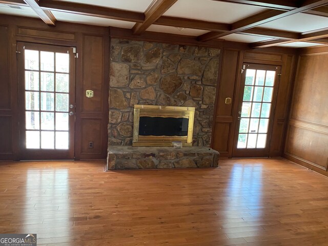 unfurnished living room with light hardwood / wood-style flooring, plenty of natural light, and coffered ceiling