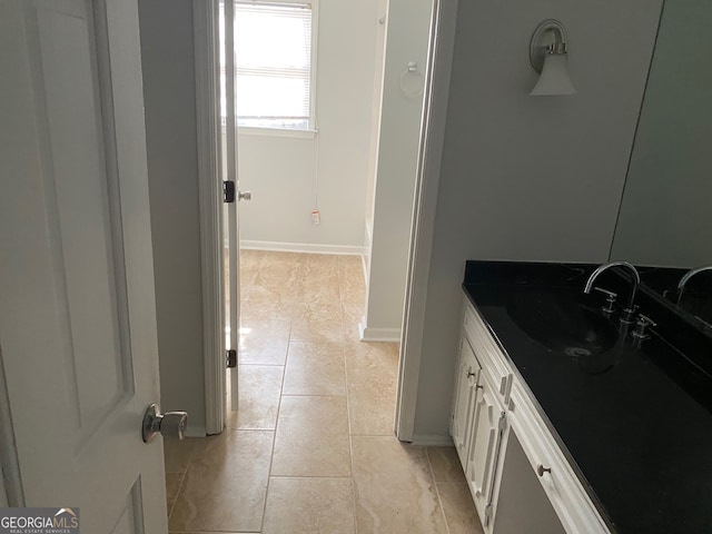 bathroom featuring tile patterned flooring and vanity