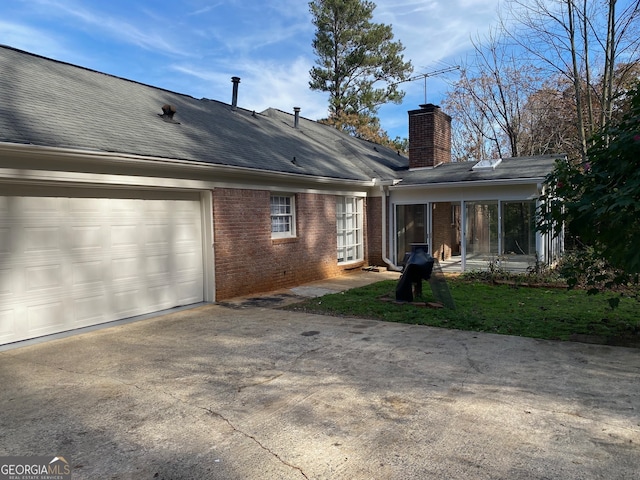 rear view of house with a garage