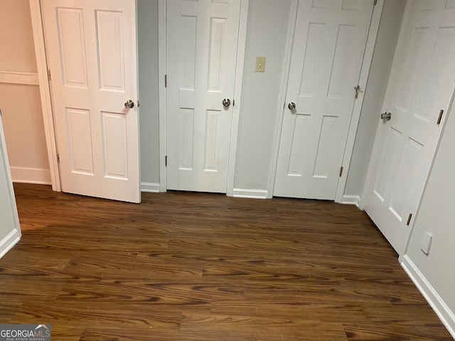 unfurnished bedroom featuring dark wood-type flooring