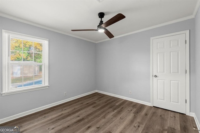 unfurnished room with dark hardwood / wood-style flooring, ceiling fan, and crown molding