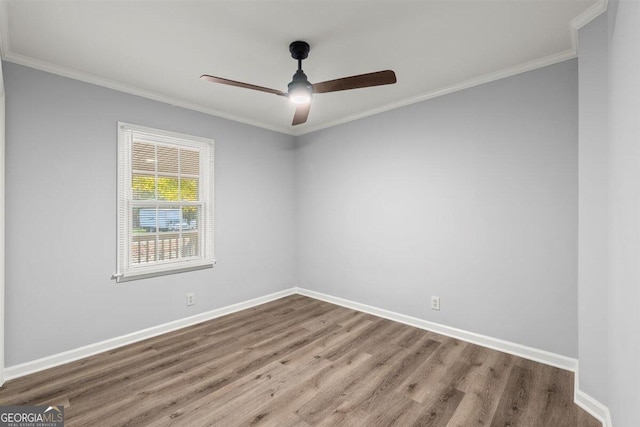 spare room featuring hardwood / wood-style flooring, ceiling fan, and crown molding