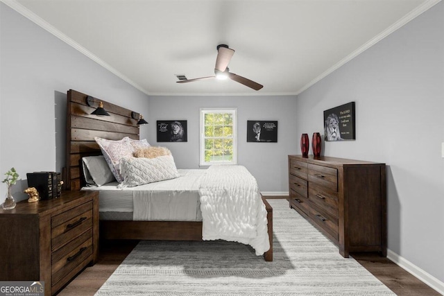 bedroom with ornamental molding, ceiling fan, and dark wood-type flooring