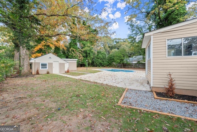 view of yard with a fenced in pool and an outbuilding