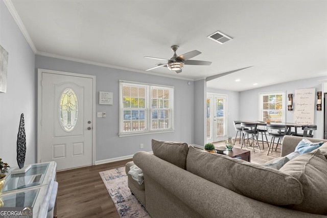 living room featuring dark hardwood / wood-style floors, ceiling fan, and crown molding