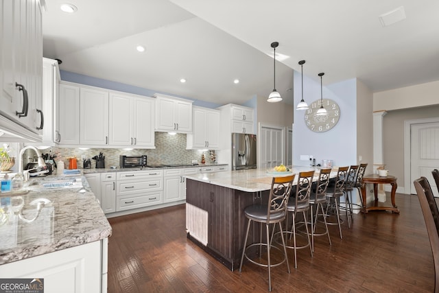 kitchen featuring white cabinets, a center island, dark hardwood / wood-style flooring, and stainless steel fridge with ice dispenser