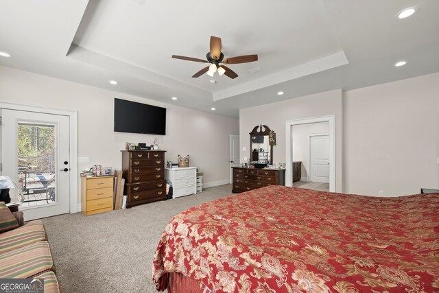 bedroom with a raised ceiling, access to exterior, ceiling fan, and carpet floors