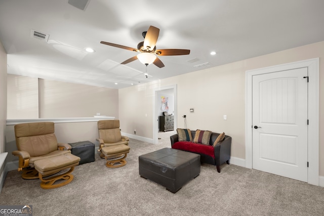 living area with ceiling fan and light carpet