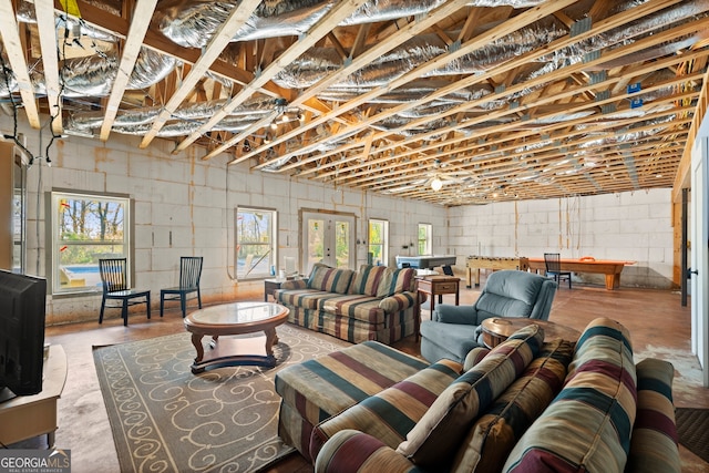 living room featuring concrete flooring and a healthy amount of sunlight