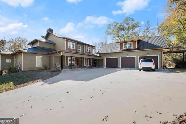 view of property featuring a porch and a garage