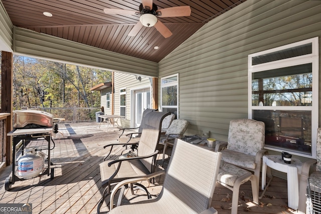 wooden terrace featuring a grill and ceiling fan