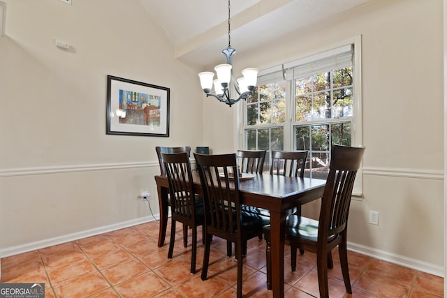 tiled dining room with a notable chandelier and lofted ceiling