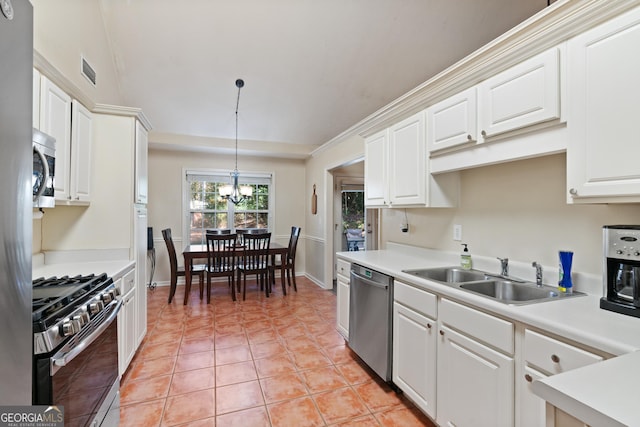 kitchen featuring white cabinetry, sink, decorative light fixtures, and appliances with stainless steel finishes