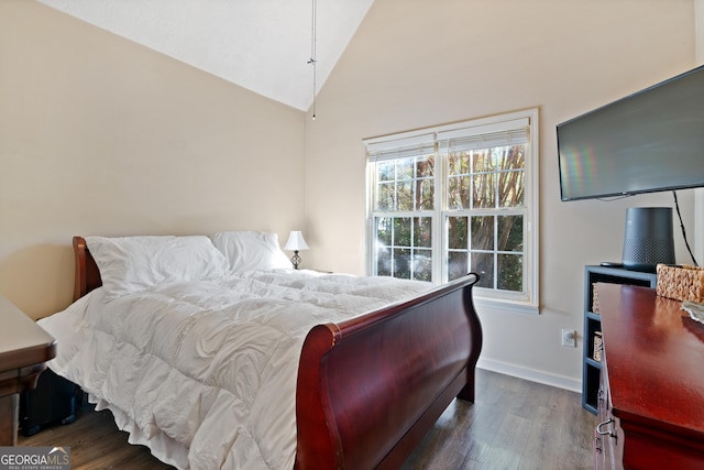 bedroom with dark hardwood / wood-style floors and lofted ceiling