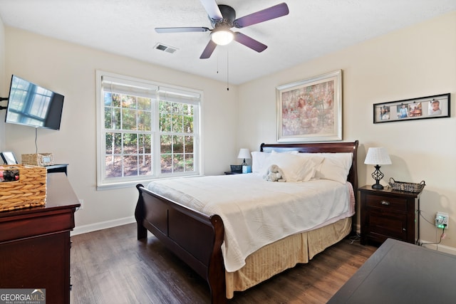 bedroom with ceiling fan and dark hardwood / wood-style floors