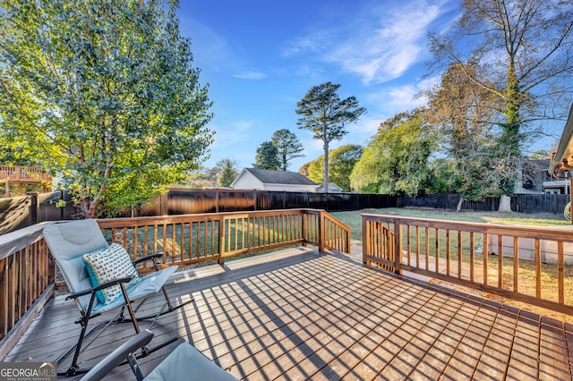 wooden deck featuring a yard