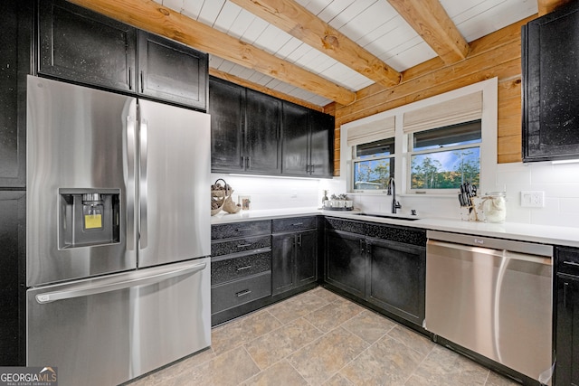 kitchen featuring decorative backsplash, stainless steel appliances, wooden walls, sink, and beamed ceiling