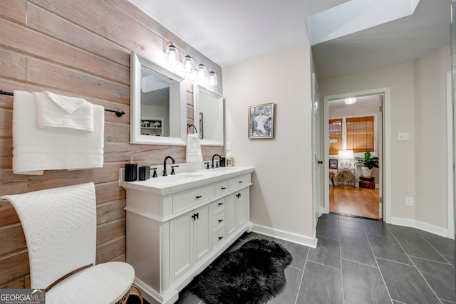 bathroom with tile patterned floors, vanity, and wooden walls