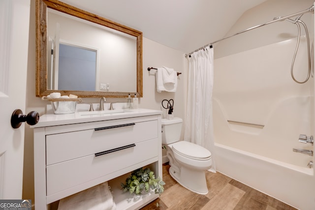 full bathroom featuring shower / bath combo, vanity, hardwood / wood-style floors, toilet, and lofted ceiling