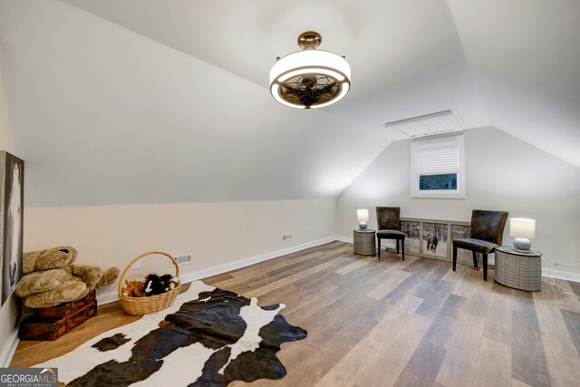 additional living space with light wood-type flooring and lofted ceiling