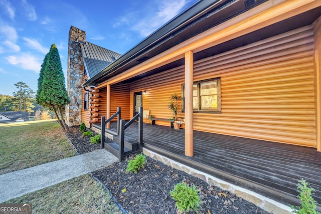 view of side of home featuring a lawn and a porch