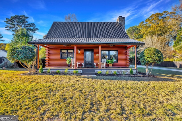 rear view of property with a porch and a yard