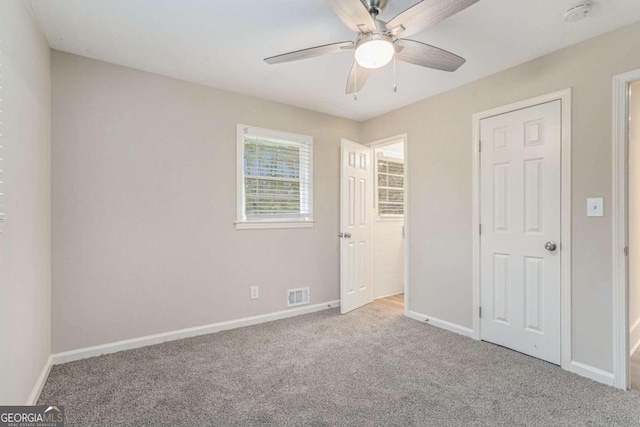 unfurnished bedroom featuring ceiling fan and light colored carpet