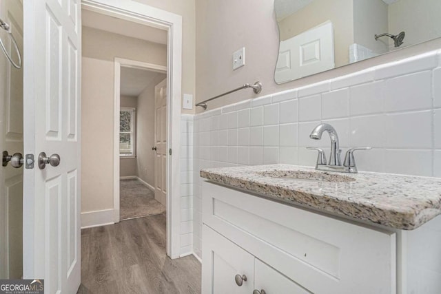 bathroom with backsplash, vanity, and hardwood / wood-style flooring