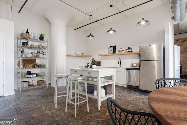 dining area with a towering ceiling and sink