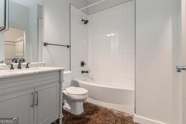 full bathroom with vanity, tiled shower / bath combo, and toilet