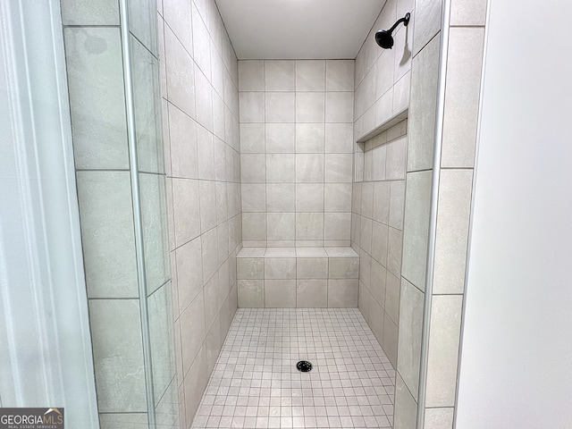 bathroom with a tile shower