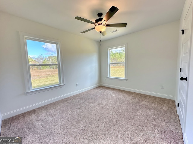 carpeted empty room featuring ceiling fan