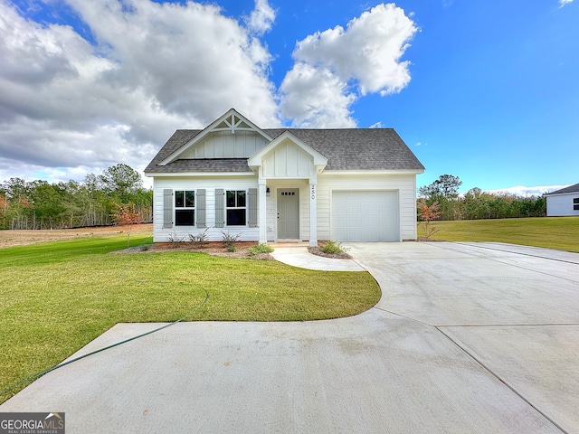 view of front of property featuring a garage and a front lawn