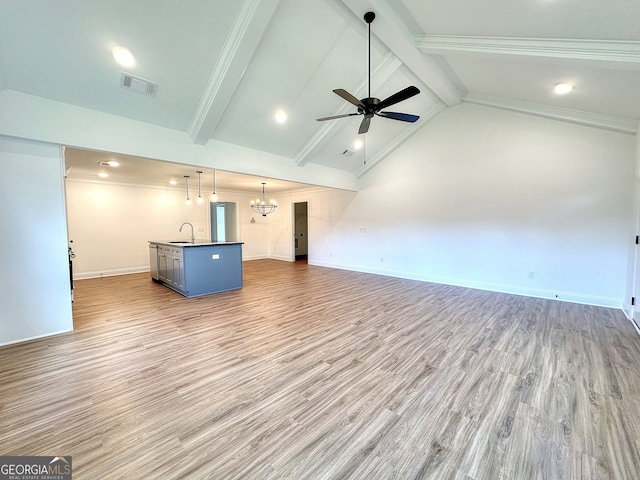 unfurnished living room featuring ceiling fan with notable chandelier, crown molding, sink, hardwood / wood-style flooring, and beamed ceiling