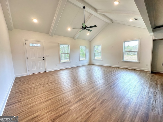 unfurnished living room with beamed ceiling, light hardwood / wood-style flooring, plenty of natural light, and ceiling fan