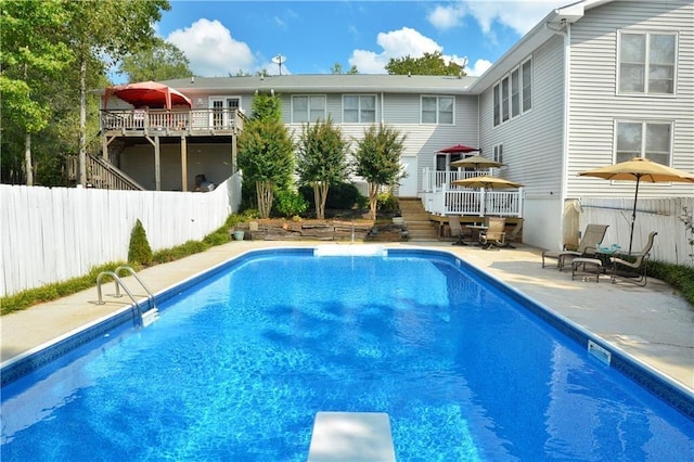 view of pool with a patio area and a wooden deck