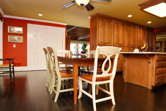 dining area featuring ceiling fan, dark hardwood / wood-style flooring, and ornamental molding