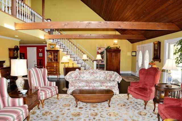 living room with crown molding, french doors, lofted ceiling with beams, and wooden ceiling