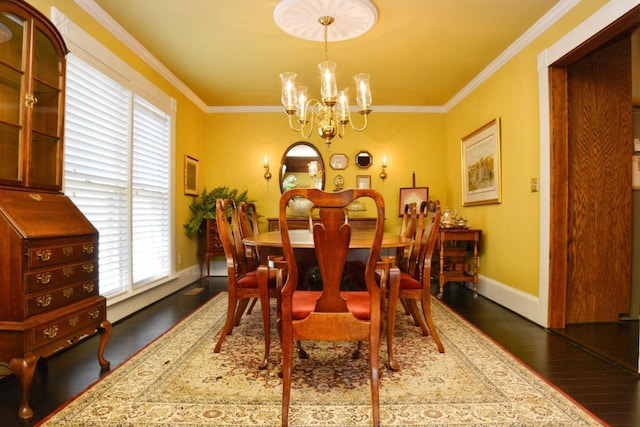 dining space with dark hardwood / wood-style floors, crown molding, and a notable chandelier