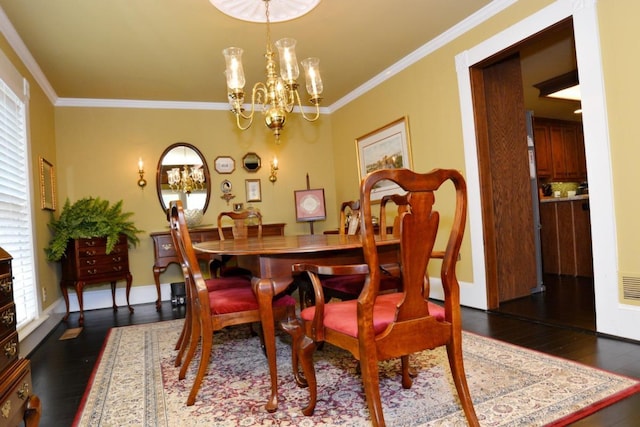 dining space with dark hardwood / wood-style flooring, crown molding, and an inviting chandelier