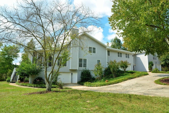 view of front facade with a front yard and a garage